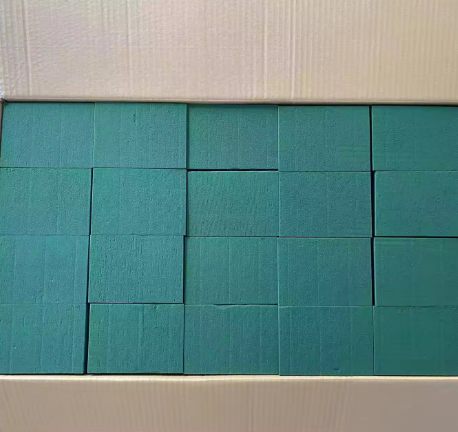 Box of multiple wet floral foam blocks neatly arranged.