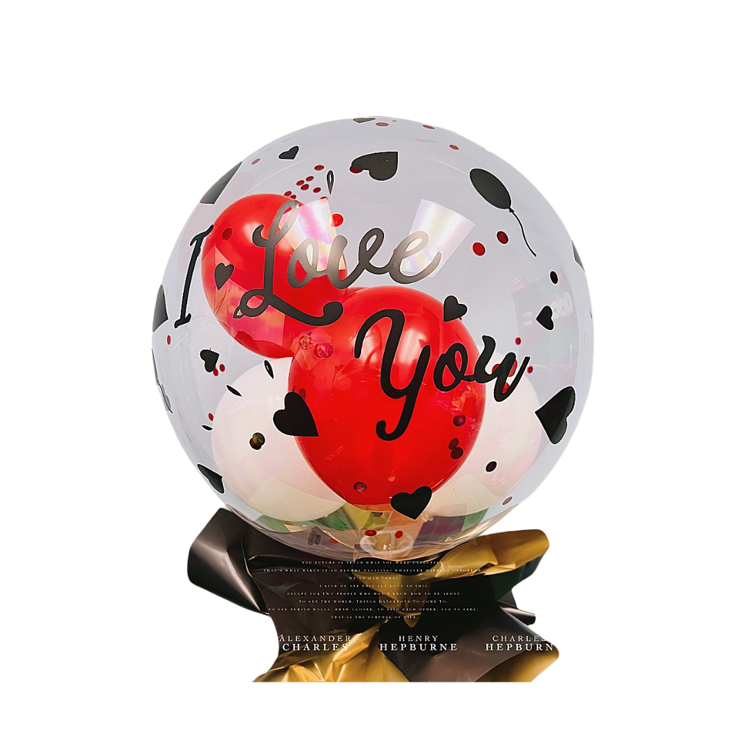 A clear balloon with "I Love You" lettering in black and red, filled with red and white balloons, adorned with heart shapes.