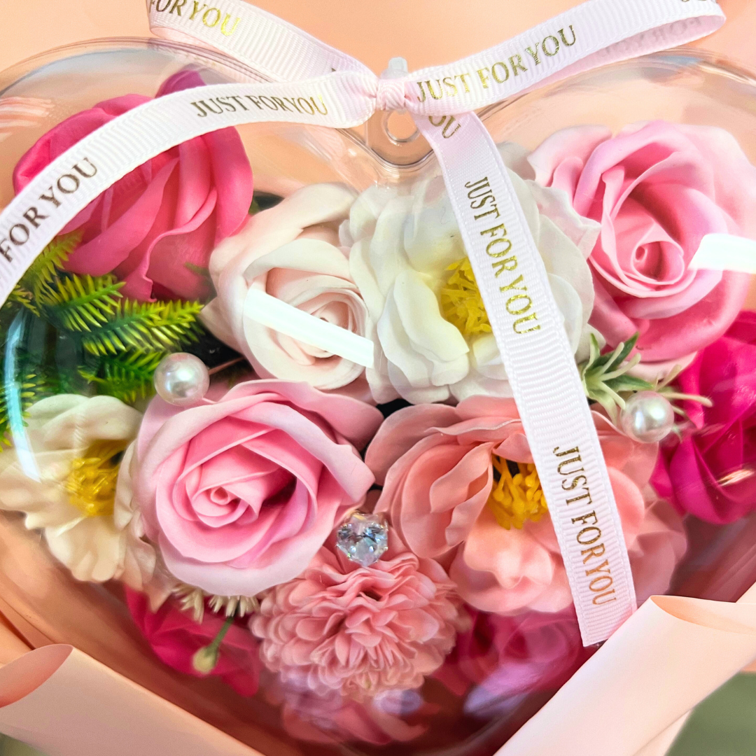 Soap pink and white soap flowers arranged in a heart-shaped bouquet with a pink "Just for You" ribbon.