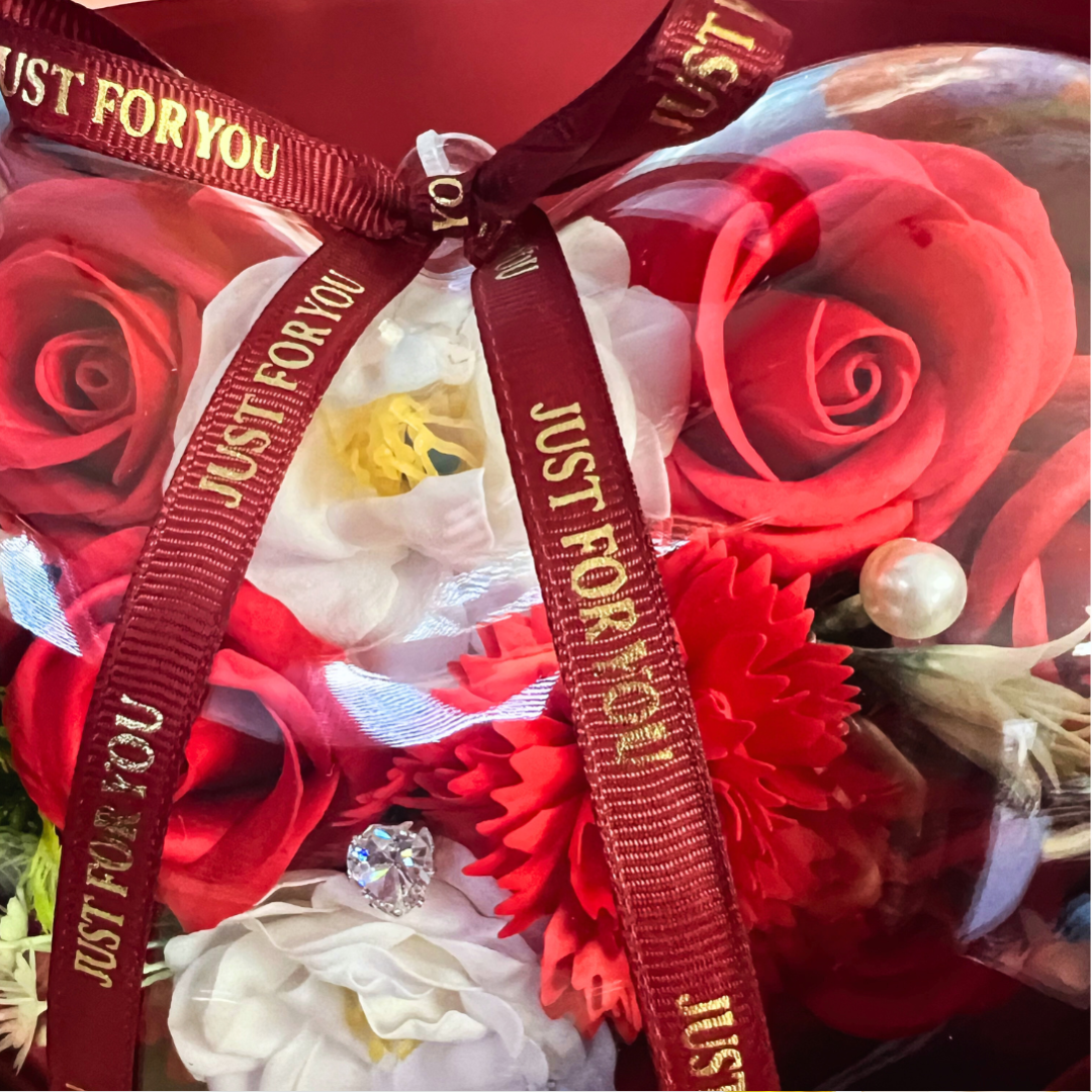  Close-up of red soap flowers in a heart-shaped bouquet with a "Just For You" ribbon.